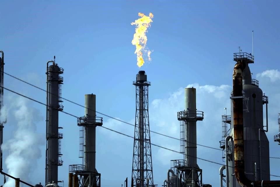 A flame burns at the Shell Dear Park oil refinery Thursday, Aug. 31, 2017, in Dear Park, Texas. While it's nowhere close to record highs, retail gas, as expected, began increasing in the wake of Hur