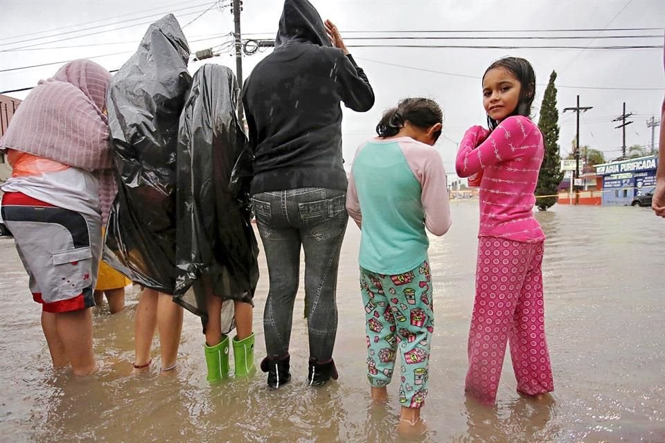 Vecinos de Las Puentes observan la crecida del Arroyo Topo Chico que se desbordó en varios puntos.