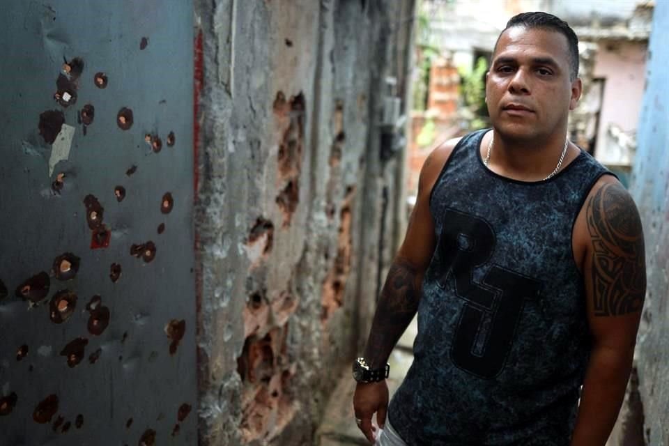 Julio César posando en un callejón repleto de balazos.