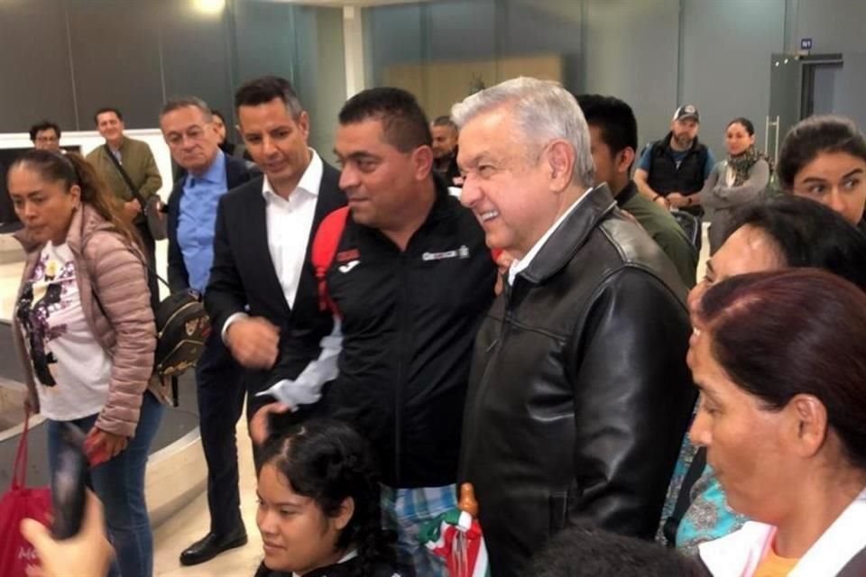 Junto a la banda de equipaje en el aeropuerto de Oaxaca, AMLO se tomó fotos con turistas; eran las 20:00 horas del 17 de octubre.