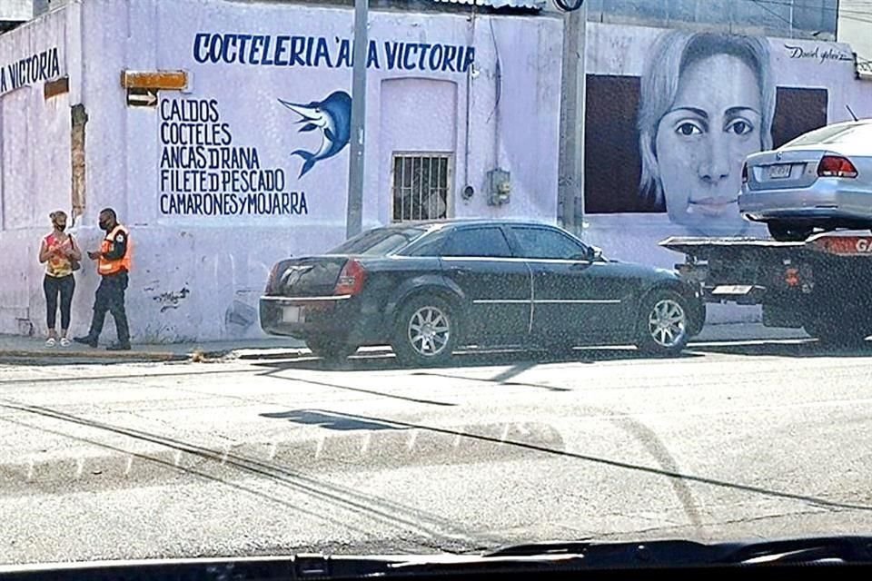 Un tránsito simula multar a una conductora por estacionarse en zona prohibida en las calles Carlos Salazar y Juan Méndez, llama a una grúa que engancha el vehículo.