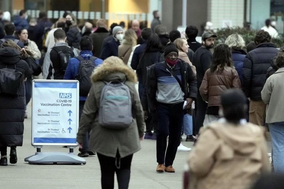 Personas hacen fila en un centro de vacunación en Reino Unido.