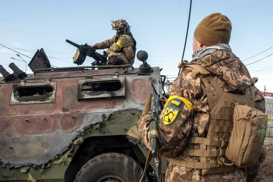 Soldados ucranianos inspeccionan un vehículo militar dañado tras combates en Járkov, el domingo.