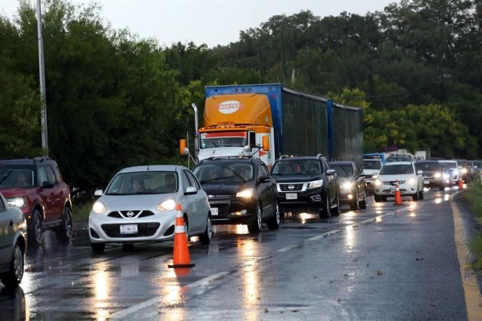 El caos vial en la Carretera Nacional se agravó ayer por una fuerte lluvia y un percance de un tráiler.