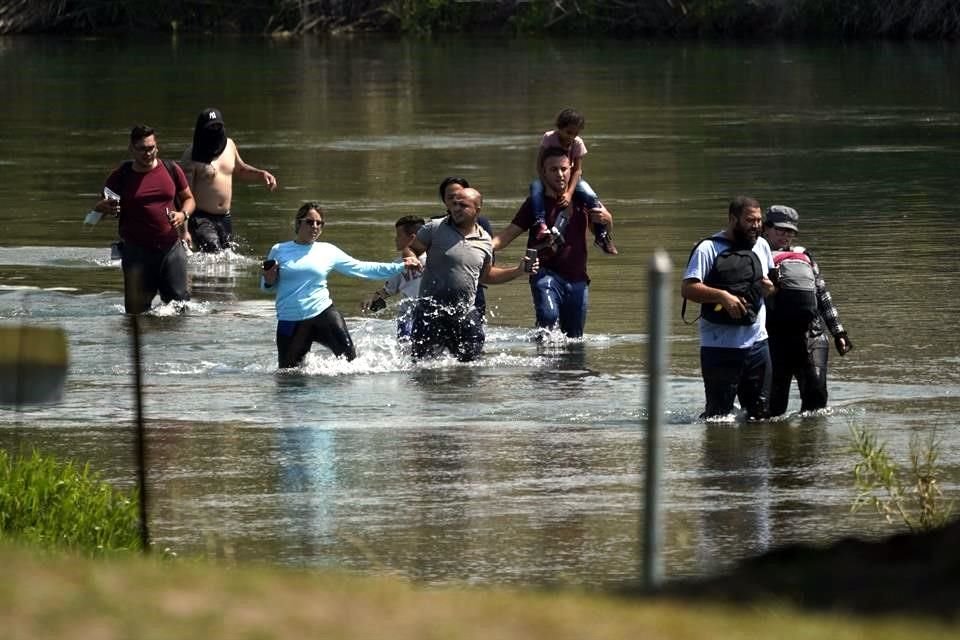 Un grupo de migrantes, la mayoría de Venezuela, cruzan la frontera entre México y EU cerca de Texas, en julio de 2021.