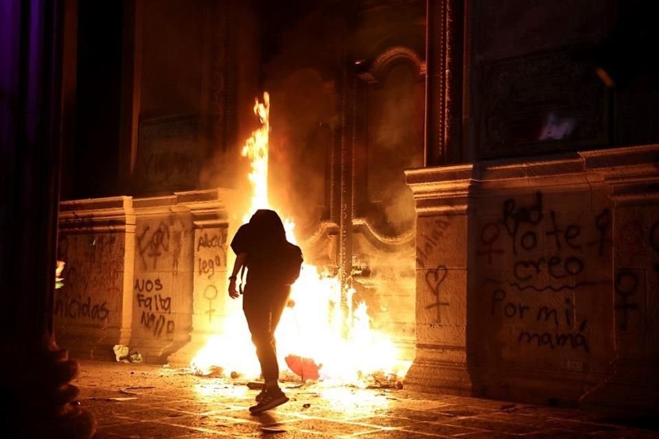 Unas de las manifestantes incendiaron la puerta del Palacio de Gobierno.