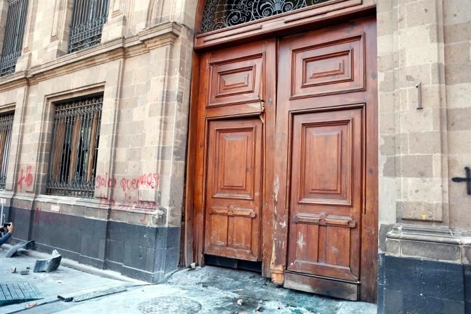 Así quedó la puerta de Palacio Nacional luego que normalistas la rompieron usando un vehículo.