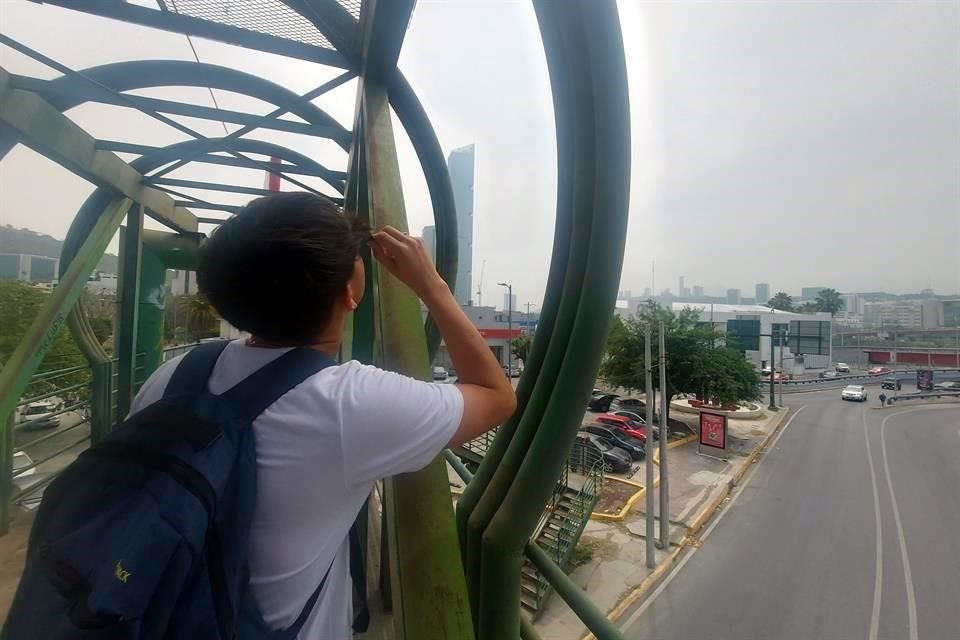 Un joven aprecia el fenómeno astronómico desde un puente peatonal en Monterrey.