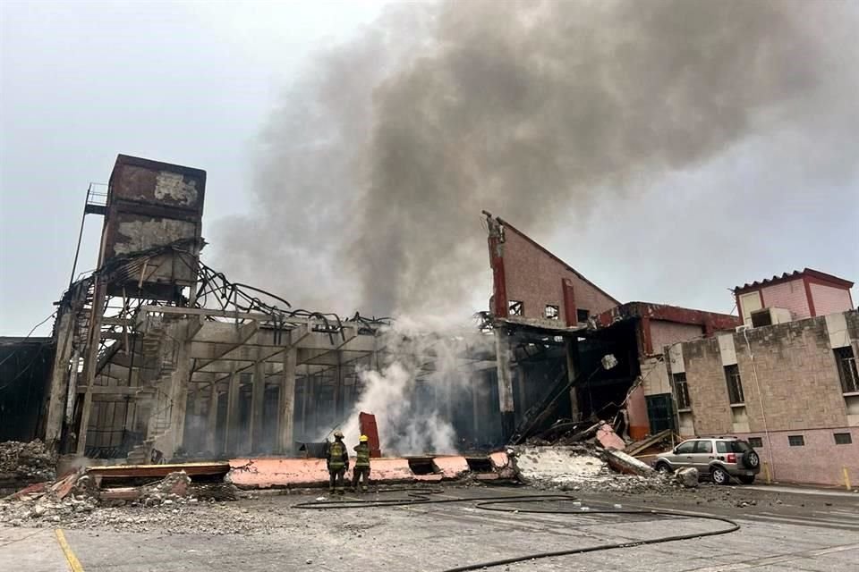 Bomberos utilizaron una escalera para combatir el fuego en la bodega.