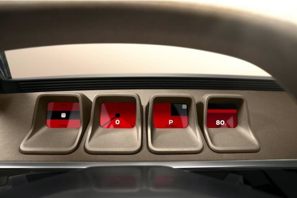 Presenta una pantalla central con el entorno gráfico actual de Renault y cuatro pequeñas pantallas geométricas detrás del volante, inspiradas en las esferas del modelo original.