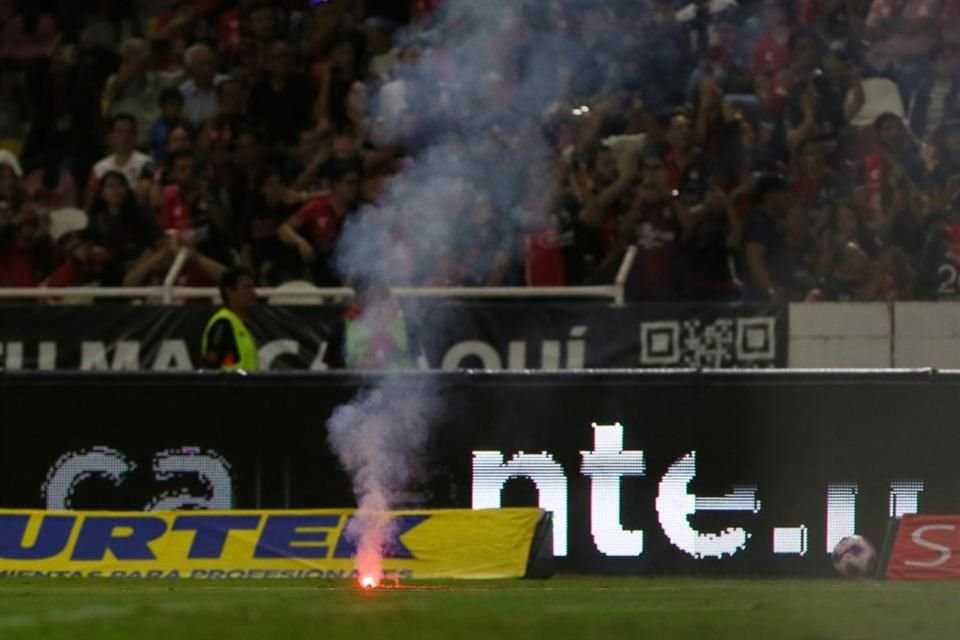 El juego se detuvo, ya que aficionados lanzaron bengalas al campo.