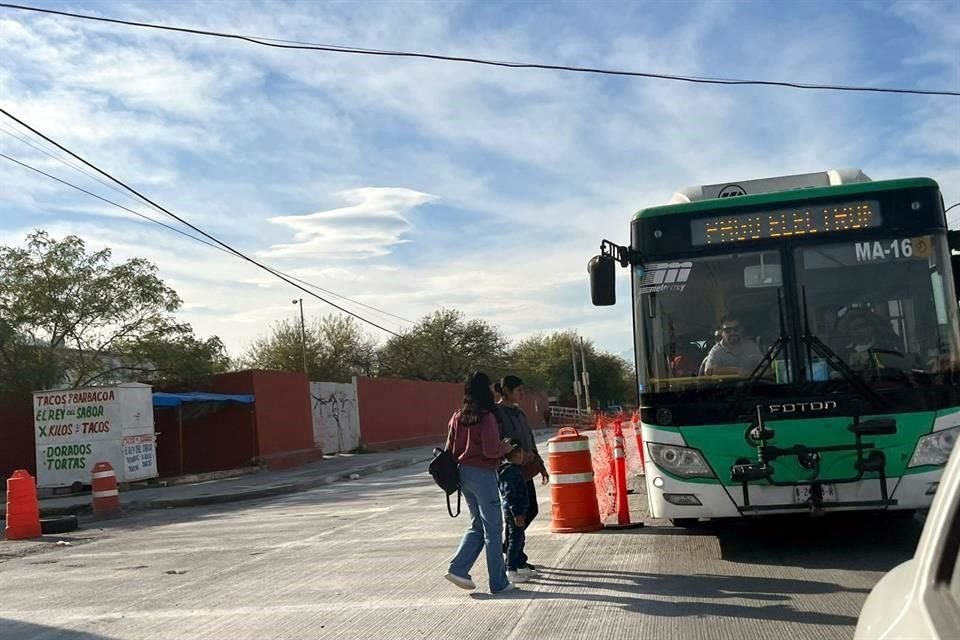 Las personas tienen que esperar al camión a media calle y entre las máquinas que trabajan en la regeneración de la avenida