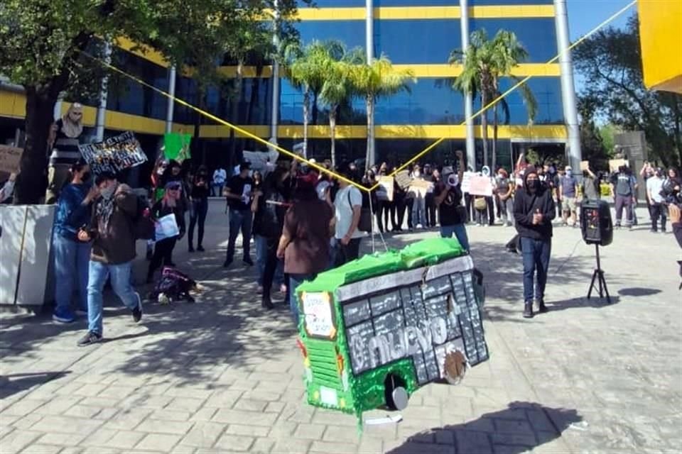 Frente a la Torre de Rectoría, los manifestantes rompieron una piñata en forma de camión de transporte público.