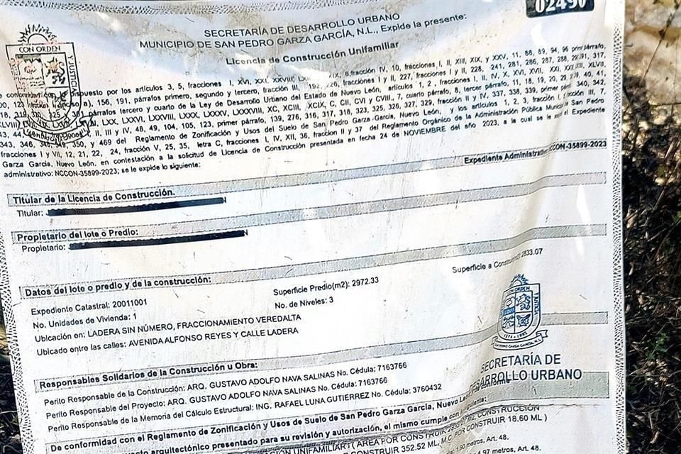 En el exterior del terreno y colgado de un árbol, está el permiso de construcción para una casa habitacional unifamiliar.