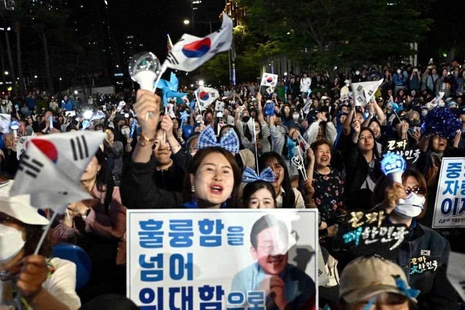 Simpatizantes de Lee Jae-myung, candidato presidencial del Partido Democrático de Corea del Sur, celebran después de que encuestas a pie de urna indicaran que Lee se encaminaba a ganar presidenciales.