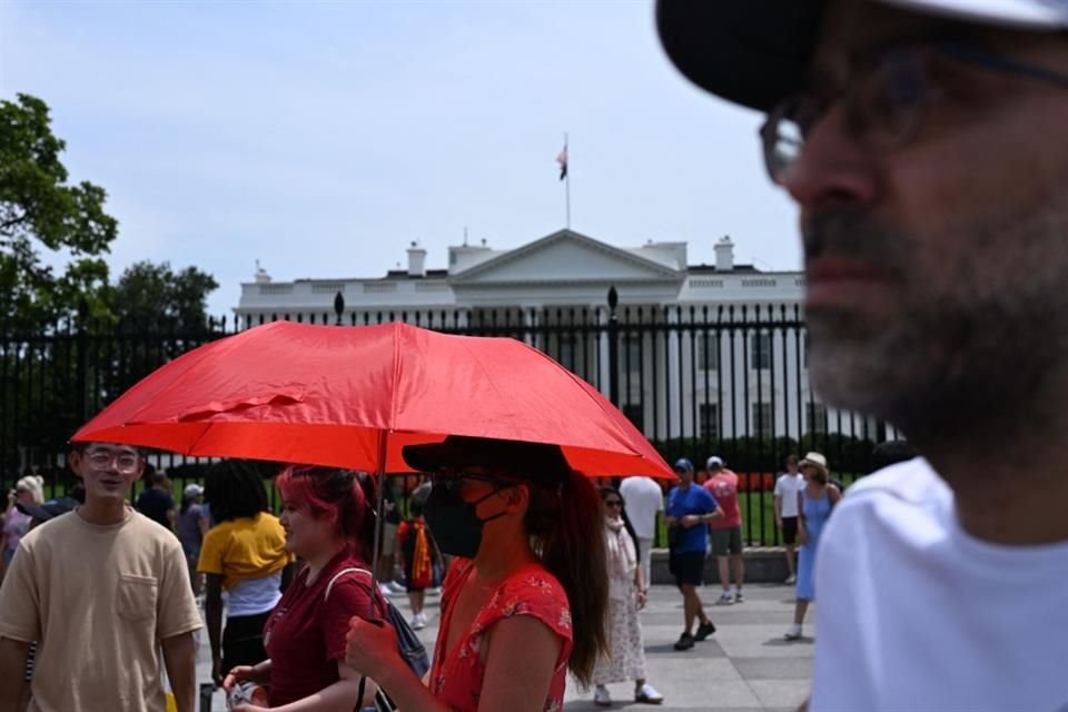 Una mujer se cubre con un paraguas afuera de la Casa Blanca, el 22 de junio del 2025.