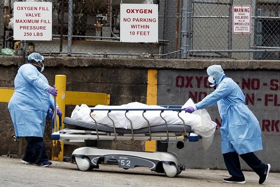 Personal médico transporta un cuerpo en Brooklyn, Nueva York.